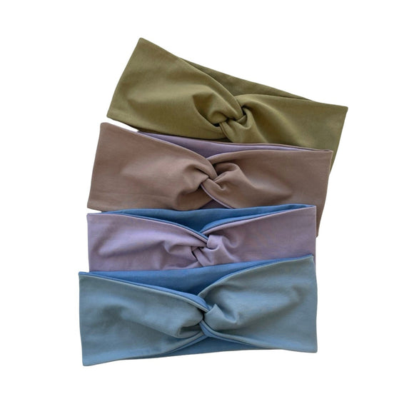Four colorful headbands arranged in a row on a white background