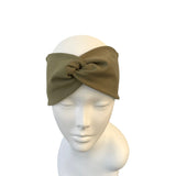 Green headband on a mannequin head against a white background