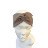 Brown headband on a mannequin head against a white background