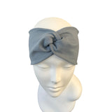 Gray headband on a mannequin head against a white background