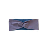 Blue and gray headband with a knot on a white background