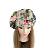 Colorful floral-patterned headscarf on a mannequin head against a white background