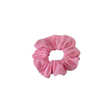 Pink scrunchie on a white background