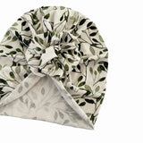 Turban with green leaf pattern on a white background