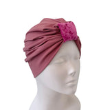 Pink headscarf on a mannequin head against a white background