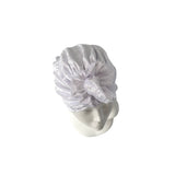 White lace headscarf on a mannequin head against a white background