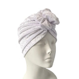 White textured headscarf on a mannequin head against a white background
