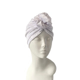 White mannequin head wearing a light gray textured headscarf on a white background
