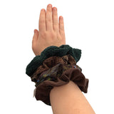 Hand wearing a green scrunchie with another brown scrunchie on a white background ireland