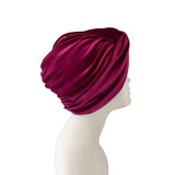Maroon headscarf on a mannequin head against a white background