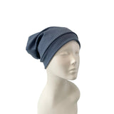Blue beanie on a mannequin head against a white background