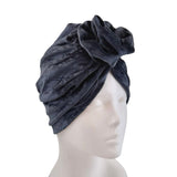 Dark gray turban on a mannequin head against a white background