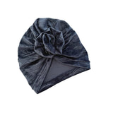 Dark blue velvet turban with a flower on a white background