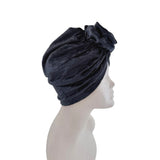Navy blue turban on a mannequin head against a white background