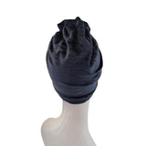 Navy blue headscarf on a mannequin head against a white background