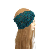 Teal lace headband on a mannequin head with long brown hair against a white background