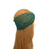 Green lace headband on a mannequin head with blonde hair against a white background
