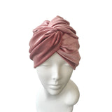 Pink turban on a mannequin head against a white background