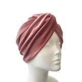 Pink turban on a mannequin head against a white background