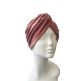Pink turban on a mannequin head against a white background