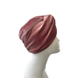 Mauve headscarf on a mannequin head against a white background
