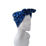 A blue and black leopard print fabric headwrap styled on a white mannequin head, shown against a plain white background.