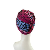 Colorful headscarf with leopard print pattern on a mannequin head against a white background
