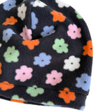 A close-up of a dark navy fleece beanie with a colorful pattern of small flowers in pink, orange, light blue, green, and white, set against a plain white background.