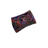 A multicolor twisted knit headband with a dense marled pattern of pink, blue, orange, and black, shown on a plain white background.