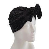 Black textured headband on a mannequin head against a white background