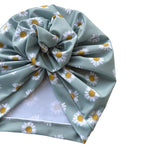 Turban with daisy pattern on a white background