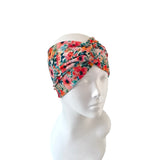 Floral patterned headband on a mannequin head against a white background