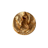 Round, beige-colored object on a white background