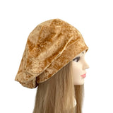 Brown velvet hat on a mannequin head with long hair against a white background