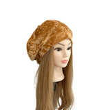 Brown beret on a mannequin head with long brown hair against a white background
