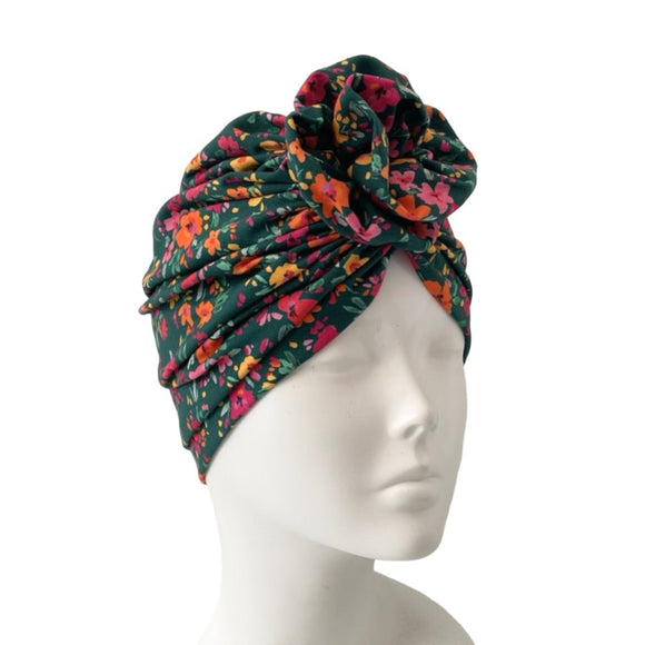 Floral patterned headscarf on a mannequin head against a white background