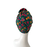 Floral patterned headscarf on a mannequin head against a white background