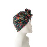 Floral patterned headscarf on a mannequin head against a white background