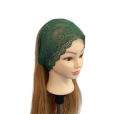 Green lace headband on a mannequin head with long brown hair against a white background