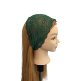 Mannequin head with green lace headband on a white background