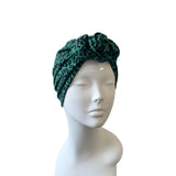 Green leopard print headband on a mannequin head against a white background