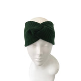 Green knitted headband on a mannequin head against a white background