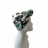 Turban with black and white pattern on a mannequin head against a white background
