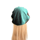 Teal hair wrap on a mannequin head with blonde hair against a white background
