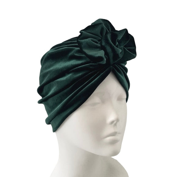 Green headscarf on a mannequin head against a white background
