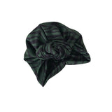 Green striped headscarf with a knot on a white background