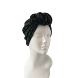 Black headscarf on a mannequin head against a white background