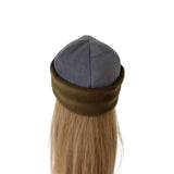 A mannequin head wearing a gray fleece kippah with an olive green fold-over band and long blonde hair visible below, photographed against a plain white background.