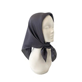 Dark gray headscarf on a mannequin head against a white background