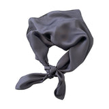 Gray silk scarf tied on a white background